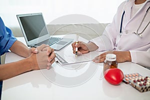 A heart patient visits a doctor for advice on health care and medication to treat heart disease symptoms after the medical team