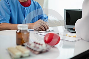 A heart patient visits a doctor for advice on health care and medication to treat heart disease symptoms after the medical team