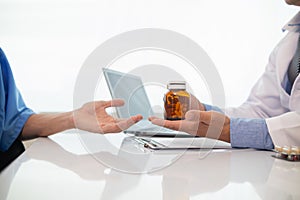 A heart patient visits a doctor for advice on health care and medication to treat heart disease symptoms after the medical team