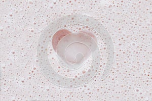 Heart on pink milkshake foam