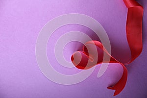 Heart of red ribbon on pink background with copyspace place for the text of the background Valentine`s Day lovers