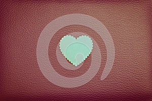 Heart on red vintage leather background