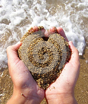 Heart of sand in hands