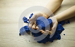 Heart of sand in the hands of a child.