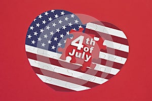 Heart shape America Flag jigsaw puzzle with a written word 4th of July