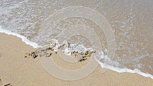 Heart shape with arrow on sand that wiped off by sea wave