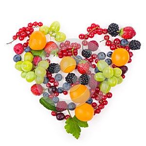 Heart shape assorted berry fruits on white background. Berries in heart shape isolateed on a white.