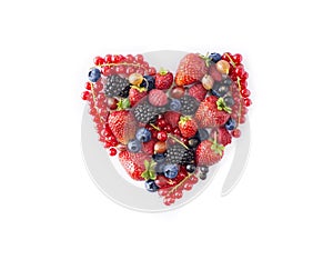 Heart shape assorted berry fruits on white background. Black-blue and red food. Ripe blueberries, red currants, raspberries, straw