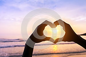 Heart shape, beach and sunset, symbol of romantic travels, love