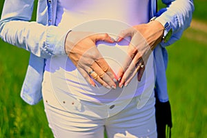 Heart shape on belly of pregnant woman