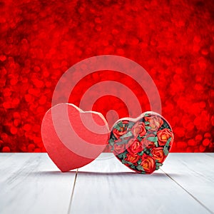 Heart shape box with red roses inside on white wood table top at blur red sparkle bokeh light background,Love concept,greeting