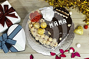 heart shape Cake for mama. Happy mother`s day background with cake and chocolate and gift box.