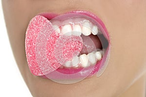 Heart shape candy on woman macro mouth