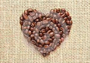 Heart shape coffee beans on sacking