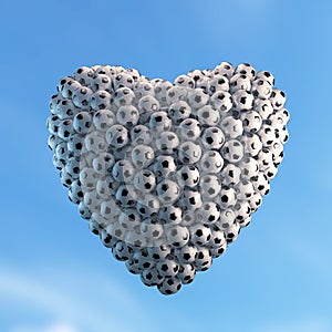 Heart shape composed of many soccer balls with dramatic lighting. High resolution image