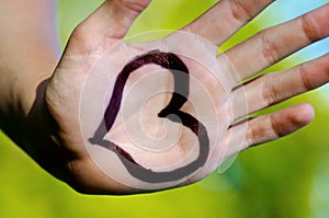 Heart shape drawed on a male human hand