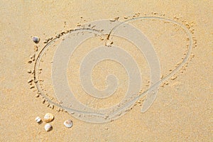 Heart shape drawing on sand beach texture background. Copy space