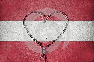 Heart shape drawning on sand with blending Austria flag