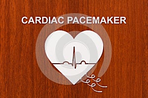 Heart shape with echocardiogram and CARDIAC PACEMAKER text. Cardiology concept