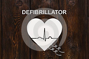 Heart shape with echocardiogram and DEFIBRILLATOR text. Cardiology concept