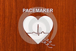Heart shape with echocardiogram and PACEMAKER text. Cardiology concept