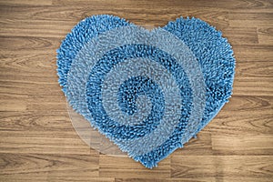 Heart shape, foot scraper carpet on wooden floor