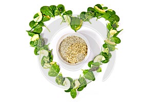 Heart Shape green Detox Salad and Vegetables with Hemp Seeds isolated on white Background