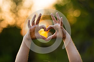 Heart shape hand of kid`s body language for children`s love, kindness, love concept. Heart Hand on nature background