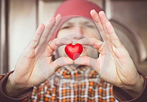 Heart shape love symbol in man hand with face on background Valentines Day