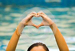 Heart shape made of beautiful hand come up from water