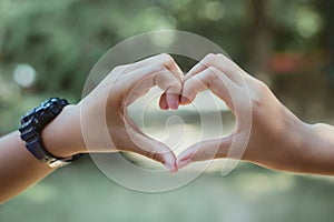 Heart shape made with hands of female student, Love symbol concept.