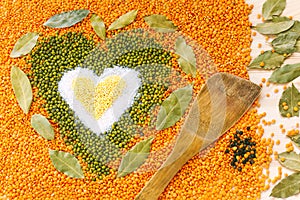 Heart shape made of mixed yellow wheat grains, white salt, green