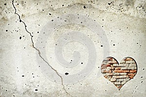 Heart shape made of old bricks on concrete wall. Valentines day background with heart shape and copy space