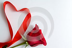 Heart shape made of red ribbon on white wooden Background. copy space - Valentines and 8 March Mother Women's Day concept