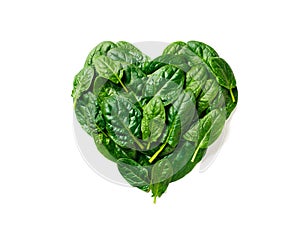 Heart shape made from spinach leaves, isolated