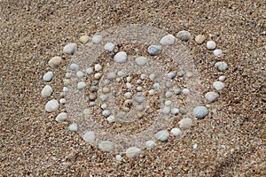 Heart shape maked of sea shells on sand