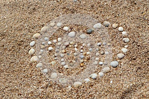 Heart shape maked of sea shells on sand