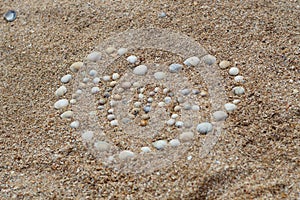 Heart shape maked of sea shells on sand