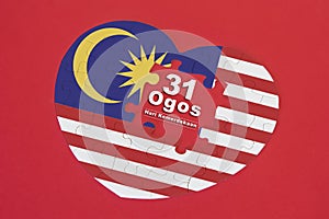 Heart shape Malaysia Flag jigsaw puzzle with a written word 31 Ogos