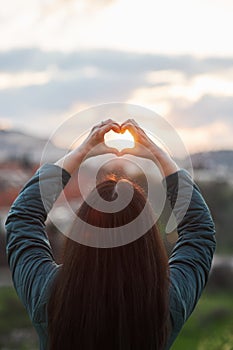 Heart-shape for the nature. female making symbol for loving