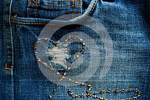 Heart shape from necklace on jeans background
