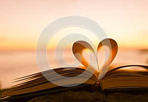 Heart shape paper book on the beach