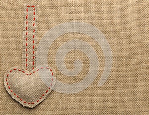 Heart Shape Sackcloth Sewing Object. Mended Burlap Background