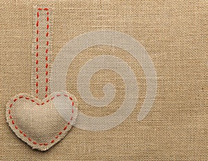 Heart Shape Sackcloth Sewing Object. Mended Burlap Background photo