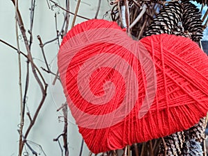 heart shape symbol made from wool.Red knitting yarn heart shaped. Valentines day minimal concept. Greeting card