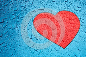 Heart shape symbol and raindrops on metal surface