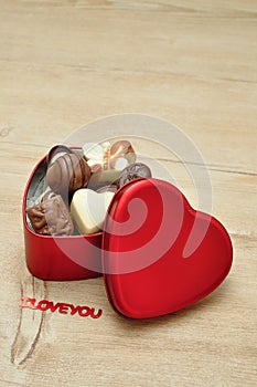 A heart shape tin filled with delicious small chocolates