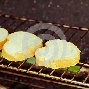 Heart shape toast on rack over stove