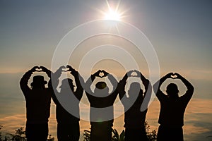 Heart shape from two hand with sunrise background