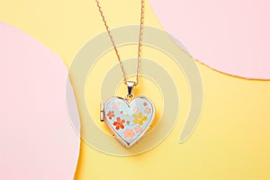 heart-shaped aromatherapy locket against pastel-colored background